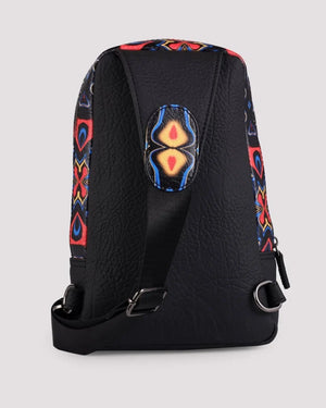 Adjustable shoulder strap detail on women’s sling bag on a light gray background