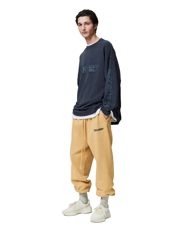 Person wearing a navy sweatshirt and beige pants on a white background