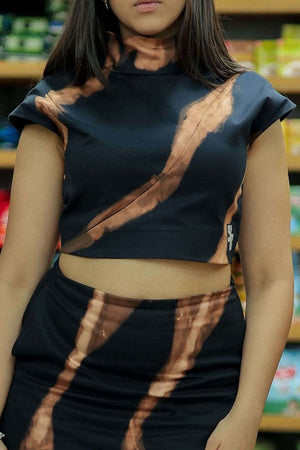 Woman in a navy blue dress standing in a grocery store aisle.