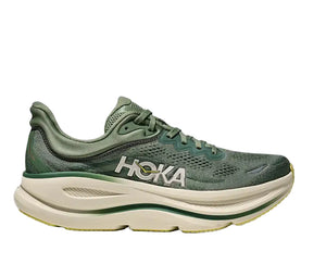 Green running shoe with 'Hoka' branding on a white background