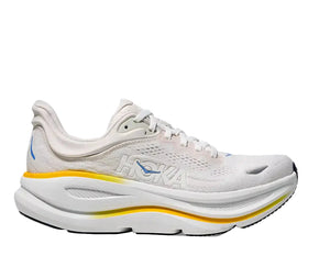 White running shoe with yellow sole on a white background