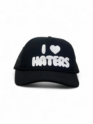 Black cap with 'I ❤️ HATERS' text on a white background