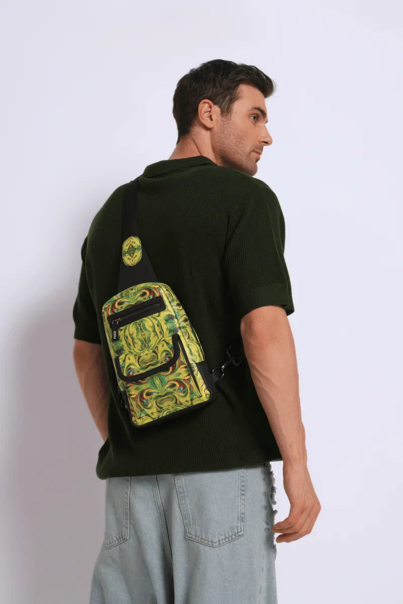 Man wearing a dark t-shirt with a kosmic immersion sling bag helios on his back against a white background