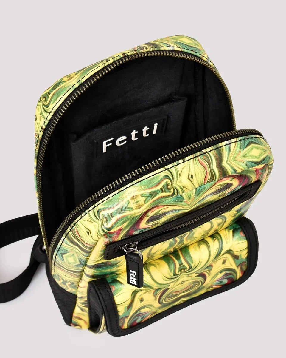 Top view of open sling bag showing interior space with 'Fetti' branding on a light gray background