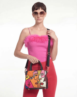 Woman holding a colorful Vegan tote bag Mini FETTI Faces on a white background